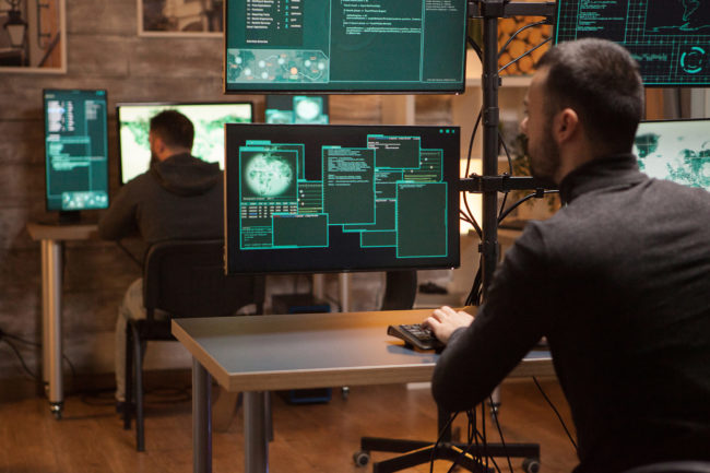 Back view of dangerous team of hackers